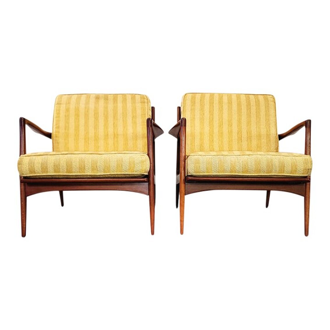 Pair Mid-Century Modern Lounge Chairs | Designed by Ib Kofod-Larsen for Selig | Made in Denmark | 1958  The chair frames are created in Denmark from Danish beech wood with a walnut finish applied using a 