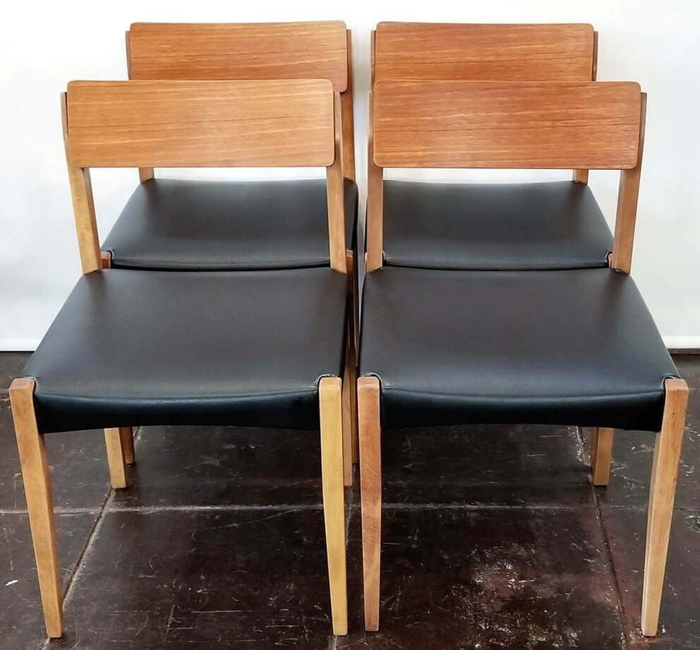 Set of four vintage Mid-Century Danish Modern birch dining chairs with teak backs and black Nappahide seats.