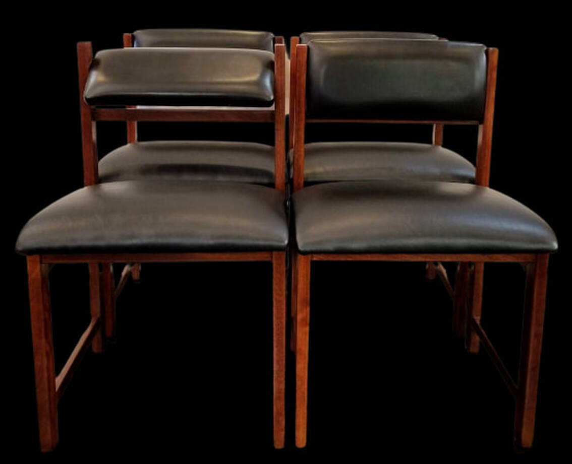 Set of four Makore wood Mid-Century Modern dining chairs with black Nappahide upholstered seats and adjustable backs.