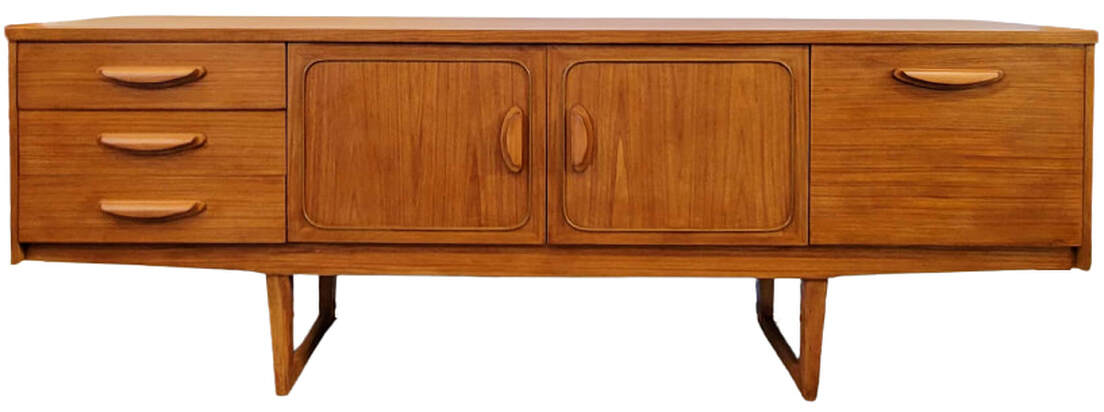 Stonehill Furniture teak credenza with sled legs is from the Stateroom Range, a line influenced by Danish Modern design. Credenza is fitted with three drawers on the left; a double-doored cabinet at center with squircle cockbead panel framing; and a fall-front cocktail cabinet on the right. Carcase is veneered with new growth Southeast Asian teak wood. The top, sides, and central cabinet doors feature crown-cut teak. 80.5