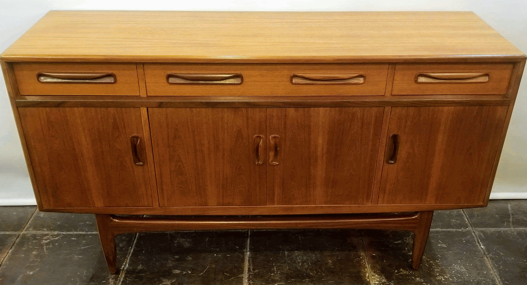 Vintage 1969 teak and afrormosia sideboard credenza manufactured by E.Gomme of High Wycombe, England, for their G-Plan Fresco Range. Buffet features three storage drawers and three shelved cabinets.